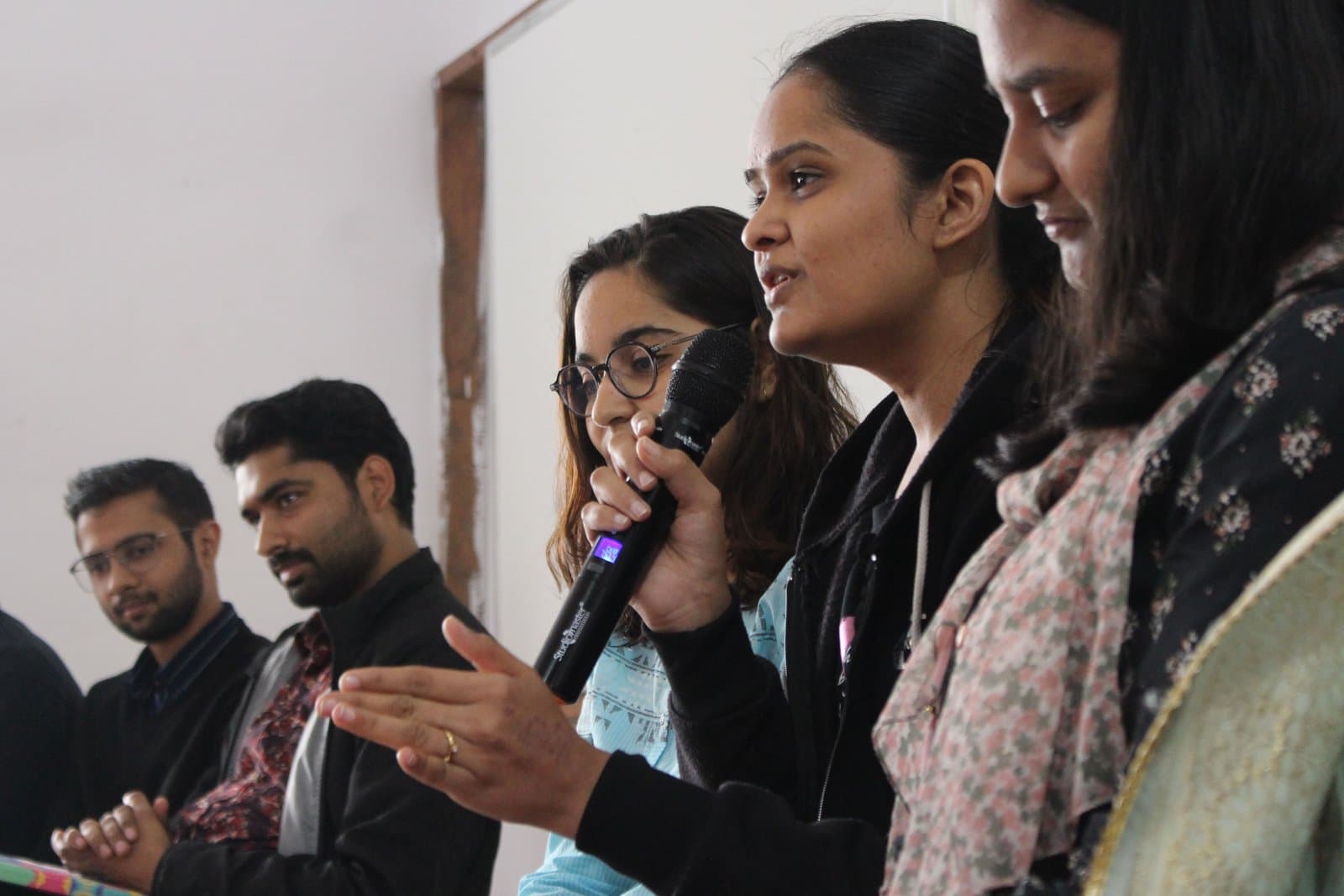 A participant asking a question into a microphone