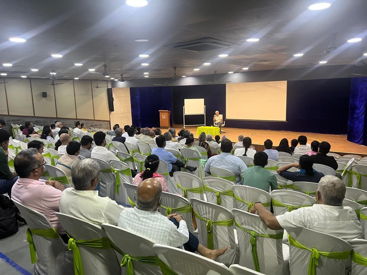 An audience seated for a talk in an auditorium