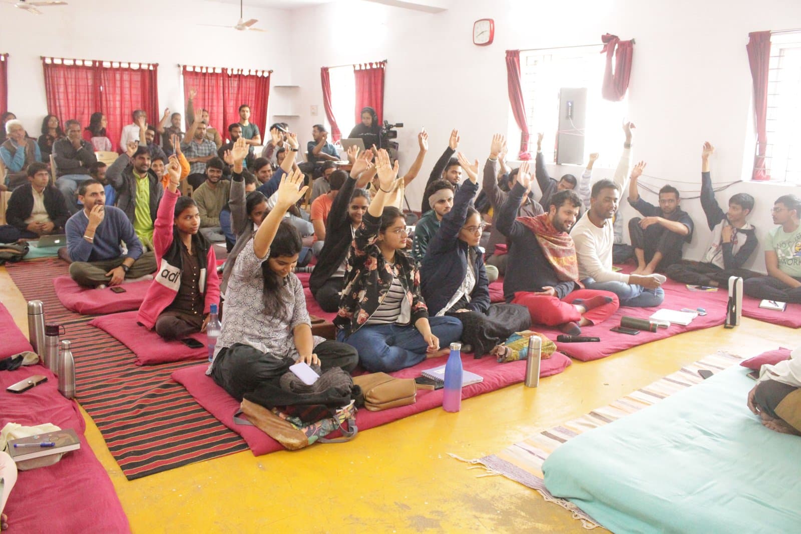 Participants raising their hands during a workshop session