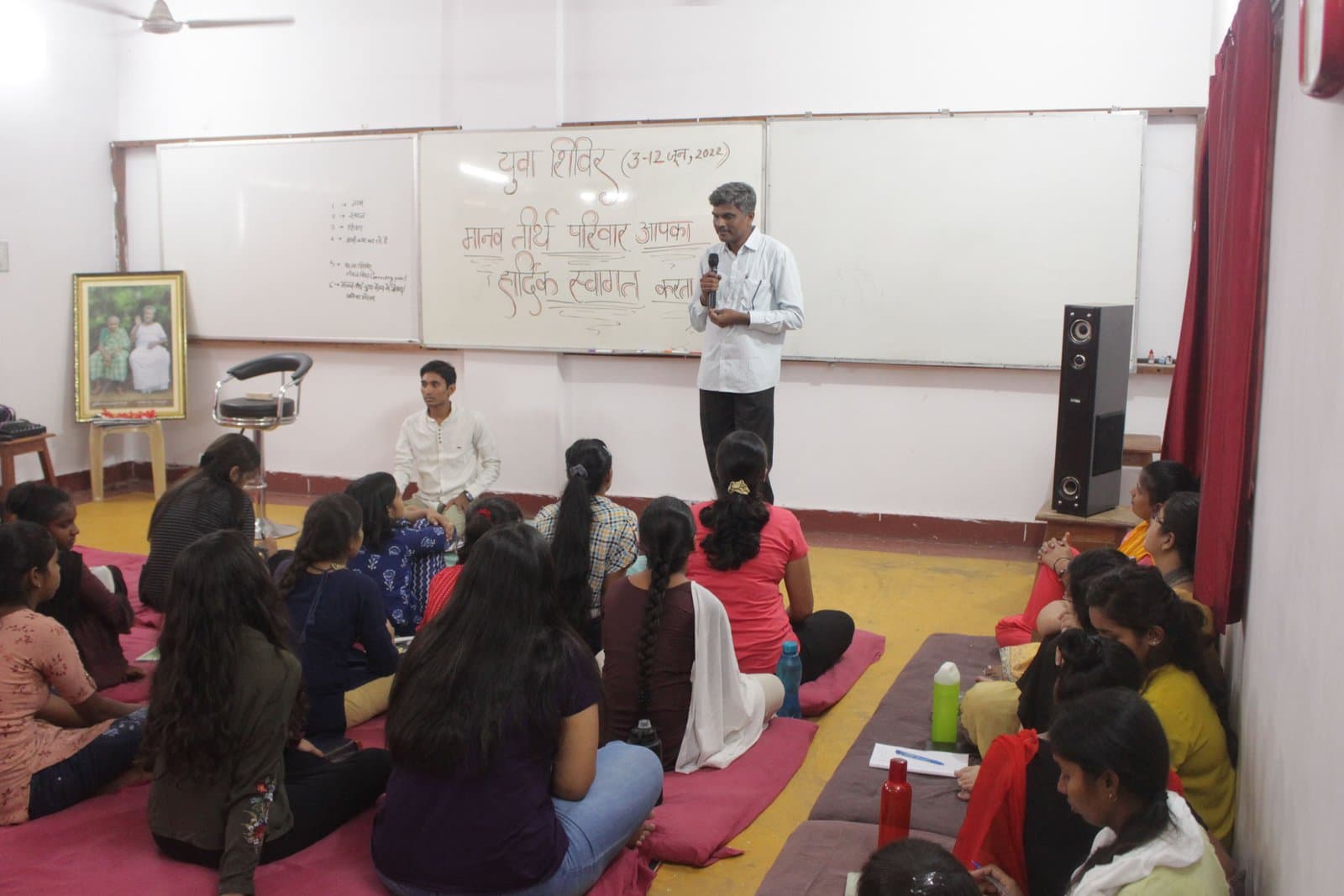 A facilitator welcoming participants at a youth camp