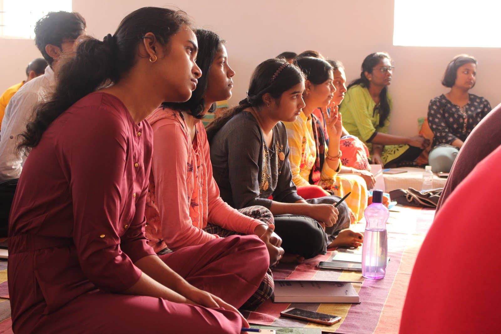 A row of participants listening closely during a session